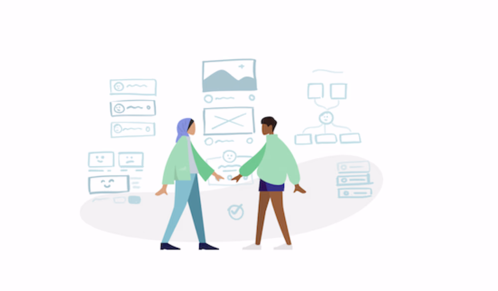 Two individuals who appear to be collaborating on something.