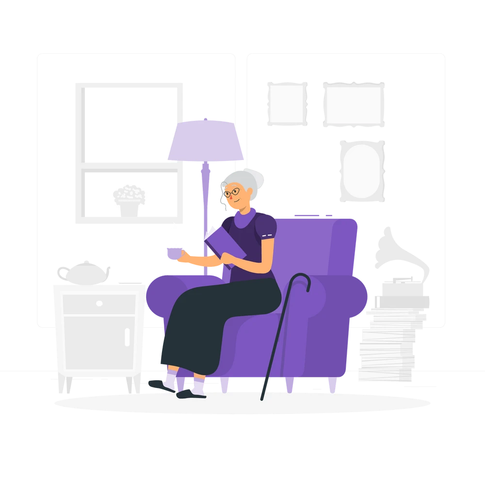 An elderly woman sitting comfortably on an armchair, holding a book in one hand and a cup in the other.